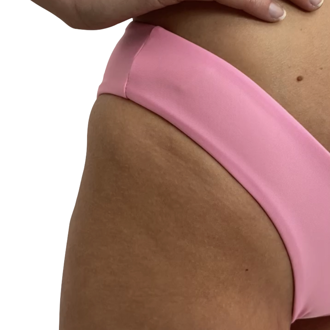 A pink bikini bottom with a V-neckline and thin sides, showcasing the product's fit and design.